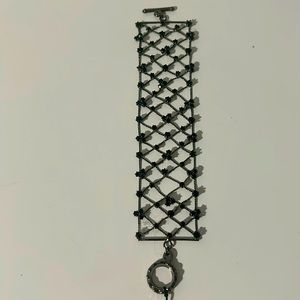 Bracelet NWT with circle/hook closure. Black netting design w/black rhinestones